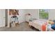 This bedroom features a comfortable twin bed, and a bright window at 3739 Capri Coast Dr, Plant City, FL 33565