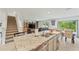 Open concept living area with a large kitchen island, dining table, and staircase at 3739 Capri Coast Dr, Plant City, FL 33565