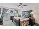 Spacious main bedroom features ceiling fan and large window at 3739 Capri Coast Dr, Plant City, FL 33565