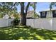 Well-manicured backyard featuring lush synthetic grass and a mature shade tree at 3809 W San Pedro St, Tampa, FL 33629