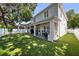 Expansive backyard with artificial turf, covered patio, and outdoor kitchen area at 3809 W San Pedro St, Tampa, FL 33629