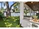 Stunning backyard featuring an outdoor kitchen and well-maintained synthetic grass at 3809 W San Pedro St, Tampa, FL 33629