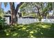 Beautiful backyard featuring lush synthetic grass and a white privacy fence at 3809 W San Pedro St, Tampa, FL 33629