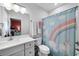 bathroom featuring a shower with a unicorn-themed curtain, a vanity, and a mirror at 3809 W San Pedro St, Tampa, FL 33629