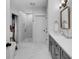 Elegant bathroom featuring a walk-in shower, quartz counters, gray cabinets, and a soaking tub at 3809 W San Pedro St, Tampa, FL 33629