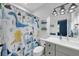 Stylish bathroom with dinosaur-themed shower curtain, modern vanity, and decorative dinosaur artwork at 3809 W San Pedro St, Tampa, FL 33629