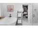 Bright bathroom featuring a soaking tub, walk-in shower, and access to a walk-in closet with custom shelving at 3809 W San Pedro St, Tampa, FL 33629