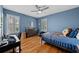 Bright bedroom with natural light, a desk, and hardwood floors creating an inviting and comfortable space at 3809 W San Pedro St, Tampa, FL 33629