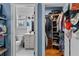 Walk-in closet with custom shelving and a view into a well-lit, modern bathroom with great storage at 3809 W San Pedro St, Tampa, FL 33629