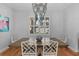 Dining room with hardwood floors, shuttered windows, a wooden table, and an elegant chandelier at 3809 W San Pedro St, Tampa, FL 33629