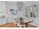 Cozy dining room with a wood table, patterned chairs, a chandelier, and natural light from shuttered windows at 3809 W San Pedro St, Tampa, FL 33629