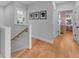 Bright hallway with hardwood floors, white trim, and stylish silhouette artwork on the gray accent wall at 3809 W San Pedro St, Tampa, FL 33629