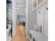 Inviting hallway with custom bench seating and storage leading to the kitchen, and a view of a decorative bathroom at 3809 W San Pedro St, Tampa, FL 33629