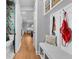 Inviting hallway featuring custom bench seating, convenient storage and a view of a decorative bathroom at 3809 W San Pedro St, Tampa, FL 33629