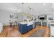 Stylish kitchen island with blue cabinetry, white countertops, pendant lighting, and stainless steel appliances at 3809 W San Pedro St, Tampa, FL 33629