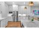 Bright kitchen showcasing white cabinets, stainless steel appliances, granite countertops, and a farmhouse sink at 3809 W San Pedro St, Tampa, FL 33629