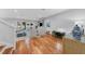 Bright and open living room with hardwood floors, a cozy seating area, and sliding glass doors to the backyard at 3809 W San Pedro St, Tampa, FL 33629