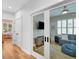 Hallway view into an extra living space, with hardwood floors and a view to another pink room at 3809 W San Pedro St, Tampa, FL 33629
