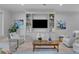 Stylish living room featuring a custom built-in entertainment center, elegant decor, and plenty of seating at 3809 W San Pedro St, Tampa, FL 33629