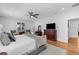 Bright main bedroom features hardwood floors, ceiling fan, white walls, shuttered windows, and a cozy area rug at 3809 W San Pedro St, Tampa, FL 33629