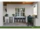 Covered outdoor kitchen with a mini-fridge, sink, and bar seating at 3809 W San Pedro St, Tampa, FL 33629