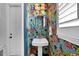 Quaint powder room featuring vibrant floral wallpaper, a pedestal sink, and stylish lighting at 3809 W San Pedro St, Tampa, FL 33629