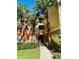 Charming condo exterior with palm trees and a well-maintained walkway and colorful paint at 4207 S Dale Mabry Hwy # 9106, Tampa, FL 33611