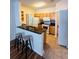 Bright kitchen featuring granite counters, wooden cabinets, breakfast bar, and modern appliances at 4207 S Dale Mabry Hwy # 9106, Tampa, FL 33611