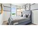 Comfortable bedroom features a well-lit window, stylish wall art, and inviting gray bed at 4414 Rachel Falls Dr, Tampa, FL 33610