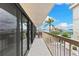 Spacious balcony showcases beautiful water views, palm trees, and comfortable outdoor seating at 479 E Shore Dr # 5, Clearwater, FL 33767
