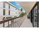 Long balcony with view of the building's architecture, palm trees, and outdoor seating at 479 E Shore Dr # 5, Clearwater, FL 33767