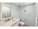 A half bathroom features a modern sink, toilet, and decorative nautical-themed artwork at 479 E Shore Dr # 5, Clearwater, FL 33767