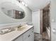 A bathroom offers a stone-lined shower, spacious vanity, and excellent lighting at 479 E Shore Dr # 5, Clearwater, FL 33767