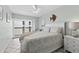 A bedroom features a queen-sized bed, balcony access and bright, coastal-themed decor at 479 E Shore Dr # 5, Clearwater, FL 33767