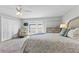 Comfortable bedroom features a ceiling fan and access to a private outdoor balcony at 479 E Shore Dr # 5, Clearwater, FL 33767