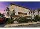 Three-story condo building with tropical landscaping and assigned parking spaces at 479 E Shore Dr # 5, Clearwater, FL 33767