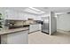 Bright kitchen features white cabinets, stainless steel appliances, granite countertops, and a skylight at 479 E Shore Dr # 5, Clearwater, FL 33767