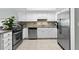 Updated kitchen offers stainless steel appliances, white cabinetry, granite counters, and tile floors at 479 E Shore Dr # 5, Clearwater, FL 33767