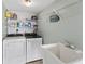 Well-equipped laundry room with washer, dryer, and a utility sink at 479 E Shore Dr # 5, Clearwater, FL 33767