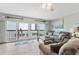 Cozy living room with sliding doors to the balcony and nautical-themed decor at 479 E Shore Dr # 5, Clearwater, FL 33767