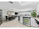 Bright, open living space with view of the kitchen, dining area, and an outside balcony at 479 E Shore Dr # 5, Clearwater, FL 33767
