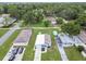 Aerial view showcasing a single-Gathering home with a well-maintained lawn and driveway, surrounded by lush greenery at 4802 18Th St, Zephyrhills, FL 33542