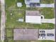 Aerial view of the area with tree lined streets, homes, sheds, and a nice lawn at 4802 18Th St, Zephyrhills, FL 33542