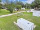 Open backyard features a long dirt driveway, a picnic table, storage, and partial fence line at 4802 18Th St, Zephyrhills, FL 33542