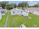 Aerial view of the long backyard, featuring a picnic table and storage container on the green lawn at 4802 18Th St, Zephyrhills, FL 33542