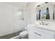 Bathroom with a glass shower, subway tiles, and a vanity with marble countertop at 4802 18Th St, Zephyrhills, FL 33542