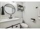 The bathroom has a sleek vanity with an eye-catching black faucet and a designer mirror at 4802 18Th St, Zephyrhills, FL 33542