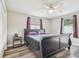 A well-lit bedroom has a ceiling fan, luxury vinyl plank flooring, and modern furnishings at 4802 18Th St, Zephyrhills, FL 33542