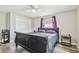 Bedroom with hardwood floors, ceiling fan, double door closet and dark furnishings at 4802 18Th St, Zephyrhills, FL 33542