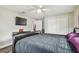 Bedroom featuring vinyl plank floors, a ceiling fan, a television and lots of closet space at 4802 18Th St, Zephyrhills, FL 33542